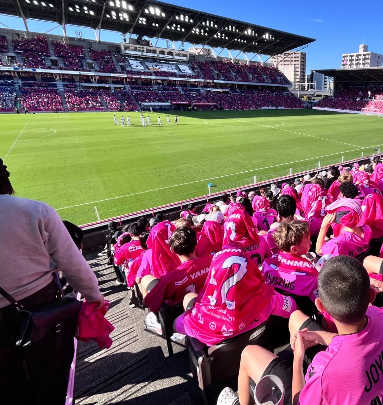 Young players in the stands at a J.League match in Osaka
